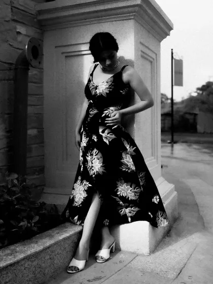 A black and white series exploring different poses against architectural elements. These shots focus on form, light, and the interaction between the subject and her environment.