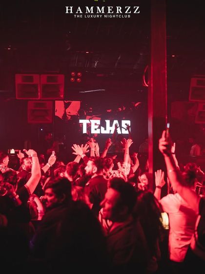 The crowd with their hands up at Hammerzz, with my name lit up on screens across the club.