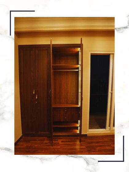 This image shows the interior of a classic wooden wardrobe, with dedicated sections for hanging clothes, drawers, and shelves for complete organization.