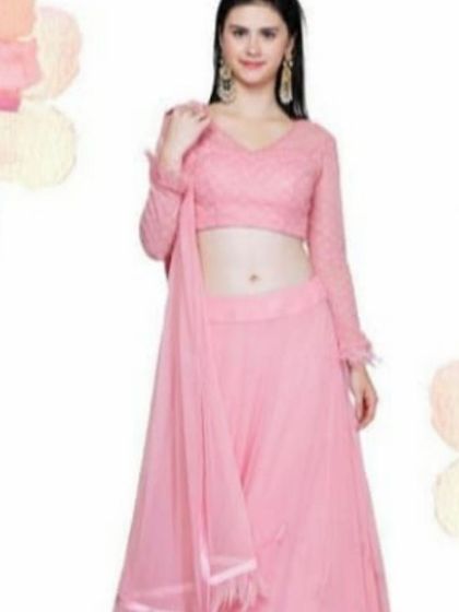 This classic pink lehenga features a full-sleeved blouse with delicate embroidery and a simple, flowing skirt. It's a timeless and graceful outfit suitable for a variety of traditional ceremonies and family functions.