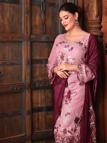 A softer, more candid pose in the same salwar suit. This shows the outfit in a more natural way, as if caught in a quiet moment.