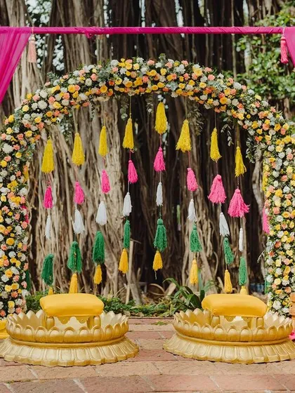 This Haldi was a carnival of colors. A vibrant floral arch and a backdrop of colorful tassels created a joyful, high-energy space for the couple to be showered with love and blessings.