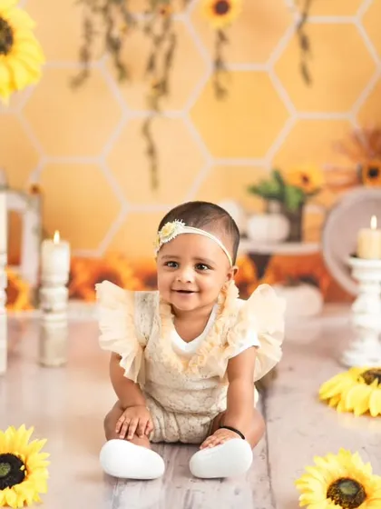A beautiful sitter portrait against our honeycomb and sunflower backdrop. The warm, golden tones of this theme create a bright and cheerful atmosphere.