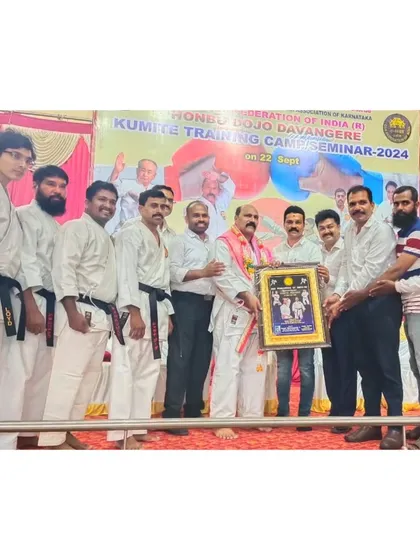 Being honored during a Kumite (sparring) Training Seminar in Davanagere. These events are crucial for students to test their skills in a controlled environment and learn practical applications of their techniques.