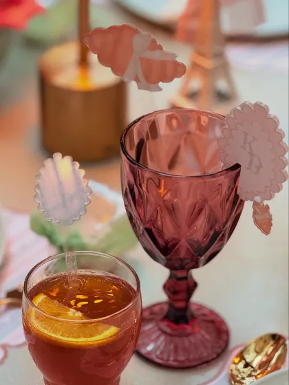 Custom acrylic drink stirrers and monogrammed glass tags add a layer of personalized elegance to the beverage service at the Parisian baby shower.