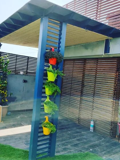 Another shot of the colorful planters on the blue pergola, a simple way to add personality and greenery.