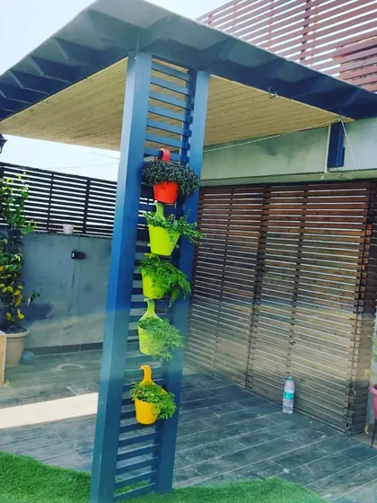 Another shot of the colorful planters on the blue pergola, a simple way to add personality and greenery.