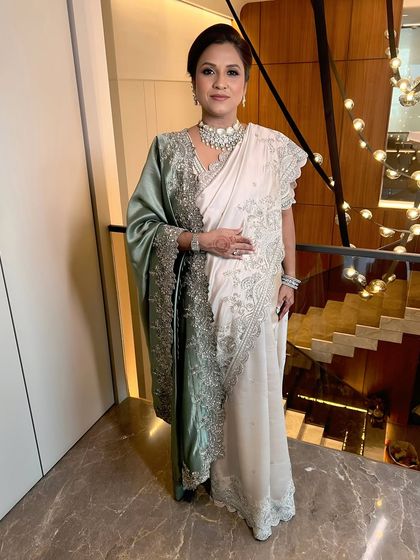 A beautiful mother-daughter duo. The mother is wearing a soft, natural makeup look that enhances her real beauty.