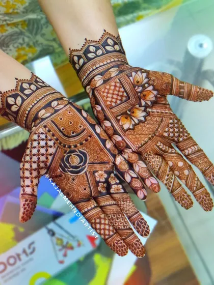 A traditional Indian henna design with a mix of floral and geometric patterns.