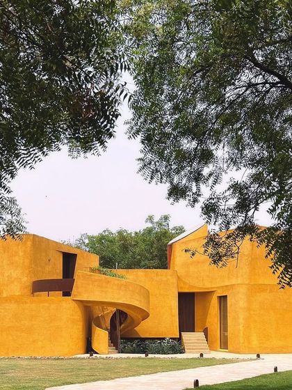 The full expanse of the main building, framed by the natural canopy of the trees on the property.