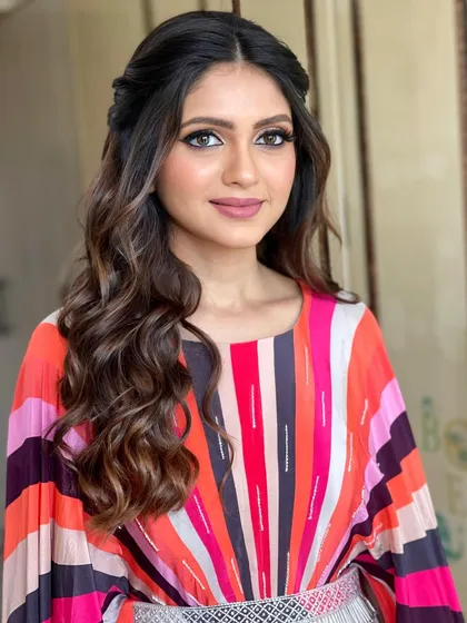 A simple and chic half-up style with soft waves for a party look.
