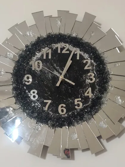 I love how this sunburst wall clock turned out! It's a real statement piece, made with a mix of sparkling crushed glass and mirrored accents to catch the light beautifully. We can customize the colors to match your living room decor.
