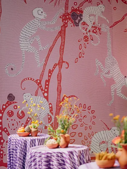 A custom-designed wallpaper featuring playful monkeys, created for a unique market-themed event. This level of personalization is what makes our events stand out.