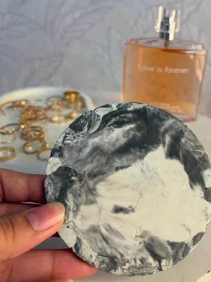 Here is my round ceramic coaster with a black and white marble effect. In the background, you can see one of my trinket trays, showing how the pieces can be styled together.