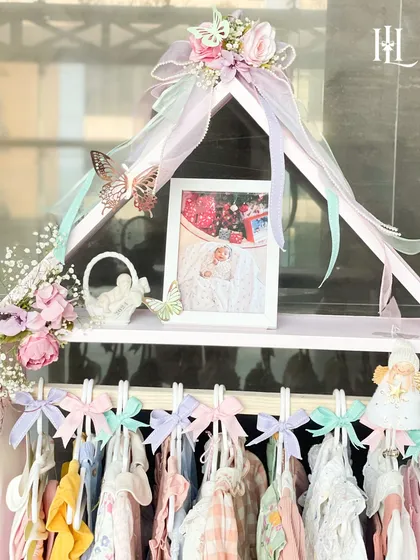 A closer look at the top of the 'Home of Love' hamper, featuring a precious photo frame, floral details, and delicate butterfly accents.