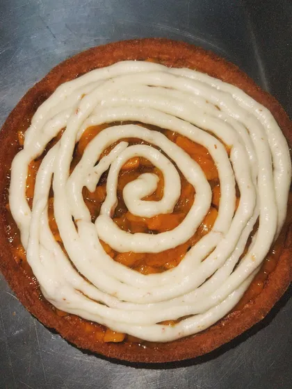 The mango compote is topped with a swirl of light vanilla bean cream, creating a perfect balance of flavors.
