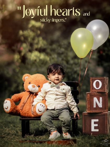 A thoughtful moment captured during an outdoor first birthday shoot. The teddy bear, balloons, and "ONE" blocks create a classic and memorable scene.