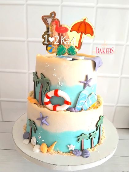 I had so much fun creating this beach-themed baby shower cake for a couple expecting twins. The "1♥2ka4" topper was a cute, personal touch for their surprise celebration.