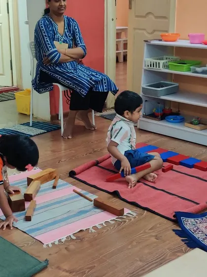 A unique aspect of our pure Montessori approach is the parent observation session. Here, a mother quietly watches her child engage in his work, gaining a true, uninterrupted window into his development and concentration in the classroom environment.