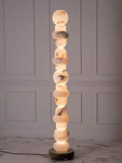 A totem-style floor lamp made from stacked pieces of marble. This is a true statement piece, combining sculpture with functional lighting.