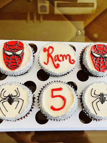 We love bringing your favorite characters to life. This custom Spider-Man themed cupcake box was for Ram's 5th birthday. It includes detailed Spider-Man masks, the iconic spider logo, and personalized touches with his name and age, all handcrafted with buttercream.
