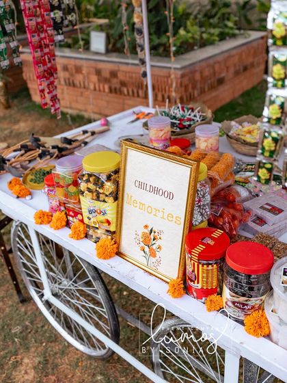 A close-up of the "Childhood Memories" sign and the array of 90s candies on the cart.