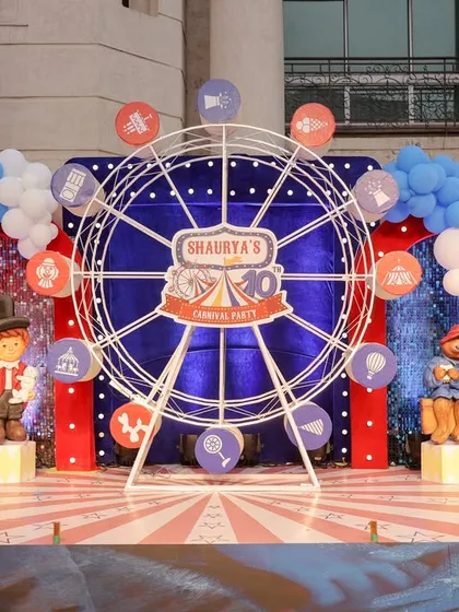 Another angle of the impressive carnival stage, showing the detailed character props and the "TEN" blocks that mark the special milestone.