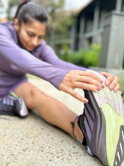 Stretching after a run in my Supernova Rise shoes. The comfort and support they provide make post-run recovery feel that much better.
