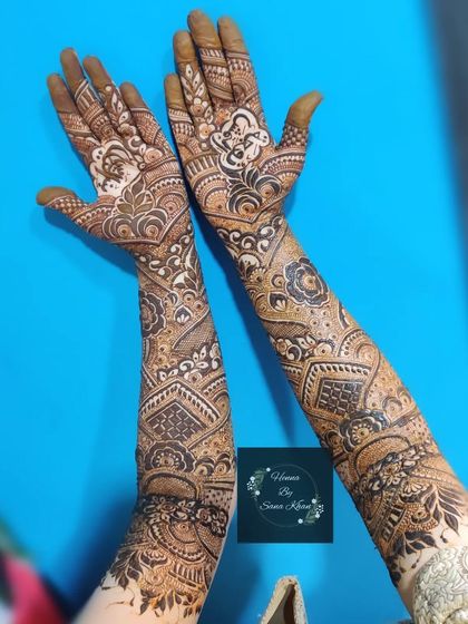 A full bridal design with a mix of geometric shapes and floral elements, showcasing a modern and structured approach to bridal henna.