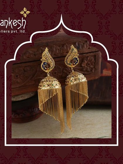 A timeless sparkle for every moment. These peacock-motif jhumkis with long, cascading gold chains are a masterpiece of design and craftsmanship.