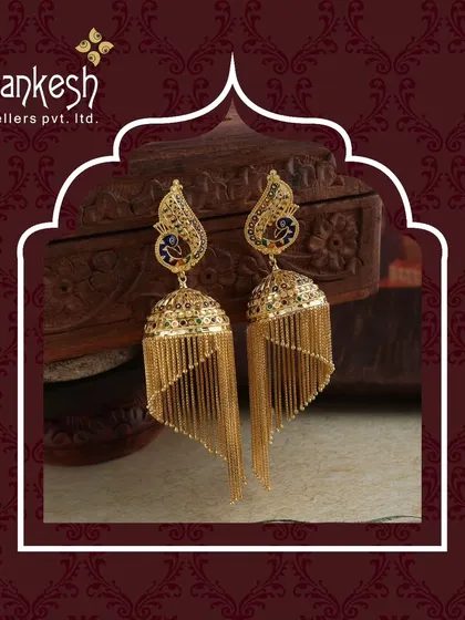 A timeless sparkle for every moment. These peacock-motif jhumkis with long, cascading gold chains are a masterpiece of design and craftsmanship.