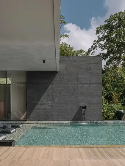 The pool area at GAIA, showcasing the minimalist architecture and its relationship with the dense, tropical foliage. The design is all about creating a private, serene outdoor sanctuary.