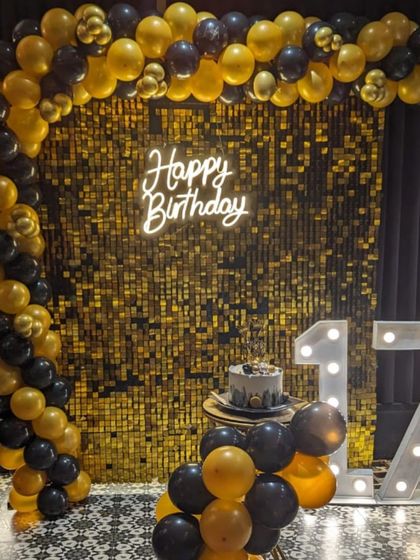 This cake was the star of a glamorous 17th birthday party, perfectly matching the black and gold balloon decor and neon lights.