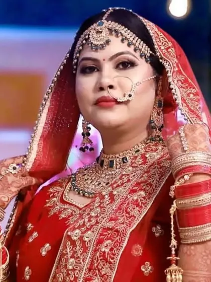 A classic Indian bride in a traditional red lehenga. I aimed for a timeless and graceful look, with perfectly defined features and makeup that complements her beautiful jewelry and outfit for her main wedding day.