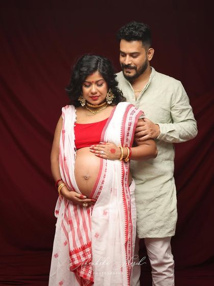 A tender moment between an expecting couple during their traditional maternity shoot. His hand on her shoulder shows his love and support on their journey.