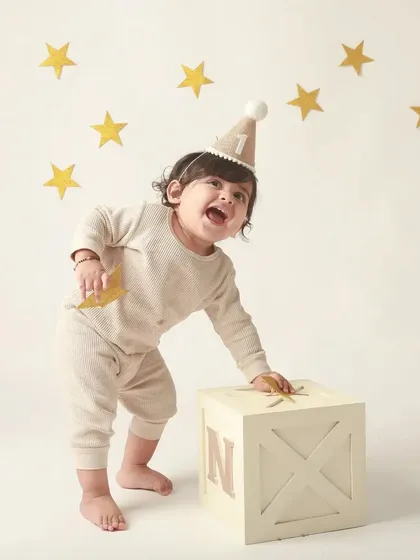 A moment of playful energy as the birthday boy interacts with the props in his star-themed shoot.