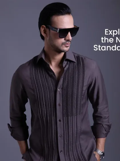 A grey shirt with a detailed pintuck and embroidered front panel. This is a shirt that speaks for you, offering a look that is sharp, clean, and confident.