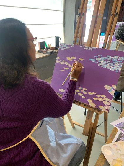 A close look at a student's brushwork as she paints water lilies, using short strokes to build up color and light.