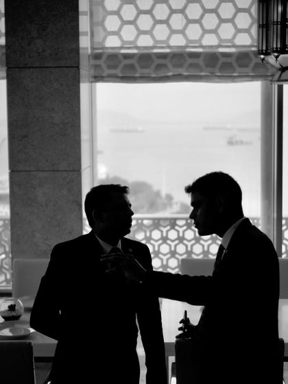 A silhouette of me in discussion at the Taj Mahal Mumbai, capturing the collaborative spirit of my events.
