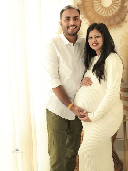 A bright and airy couple's portrait in our natural-light boho studio. The simple white dress and casual attire create a relaxed and authentic feel.