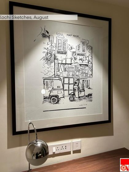 A framed sketch of Fort Kochi, created as a piece of art for a commercial space. The loose, energetic line work captures the bustling street scene with auto-rickshaws and historic architecture.