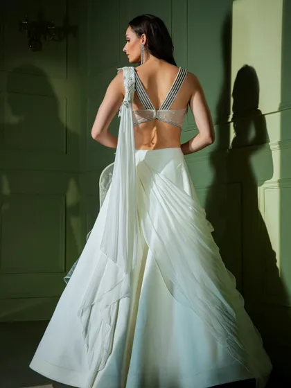 A different angle of the white ruffled gown, highlighting the craftsmanship and unique design.