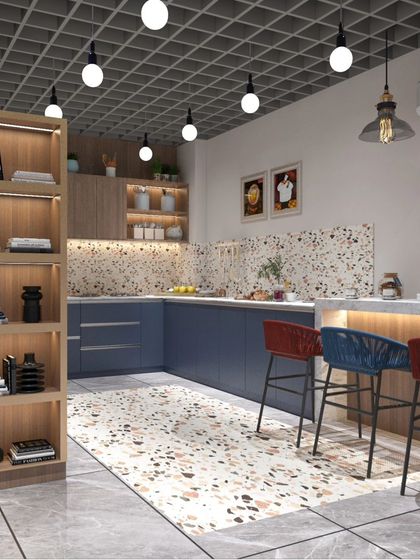 For this factory office cafeteria, we used a bold and modern design. The space features a mix of terrazzo, a striking blue and red color scheme, and an industrial grid ceiling to create a vibrant and energetic place for employees to relax.