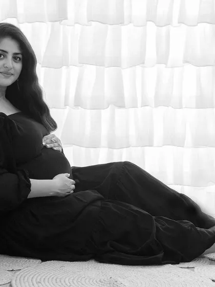 This quiet, contemplative portrait shows the beauty of black and white for solo maternity shots. The focus is entirely on the mother-to-be and the peaceful moment she is experiencing.