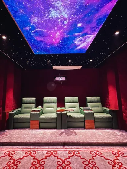 Another view of this spectacular home theater, focusing on the vibrant, custom-printed starfield ceiling. This feature adds a unique visual element that makes the space feel both grand and personal.