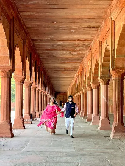 A joyful run through the historic corridors of the Taj Mahal complex. These action shots add energy and a sense of fun to your pre-wedding album.