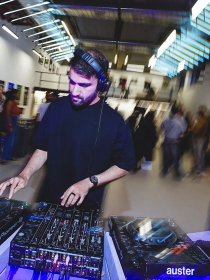 A DJ performing a set during the Boxout.fm exhibition. We activate cultural spaces with music, blurring the lines between gallery and club.