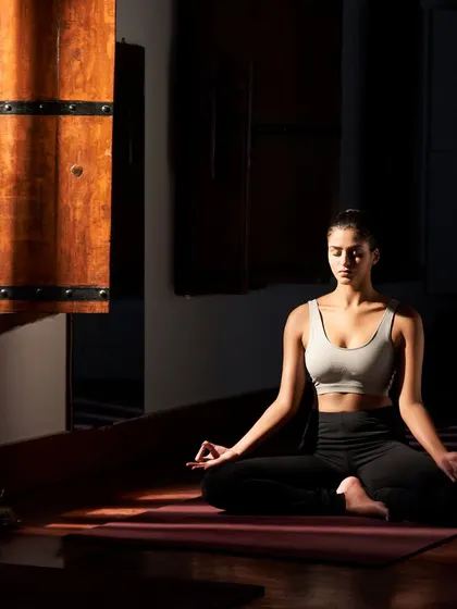 Find your inner stillness. Daily yoga and meditation are integral parts of our wellness programs, practiced in serene spaces that allow you to connect deeply with your mind and body. A sunbeam in our traditional yoga hall illuminates a moment of pure peace.
