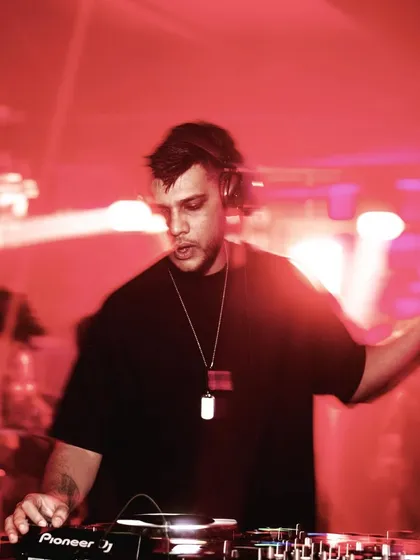 A motion-blur shot of me holding a drink while DJing, capturing the party vibe.