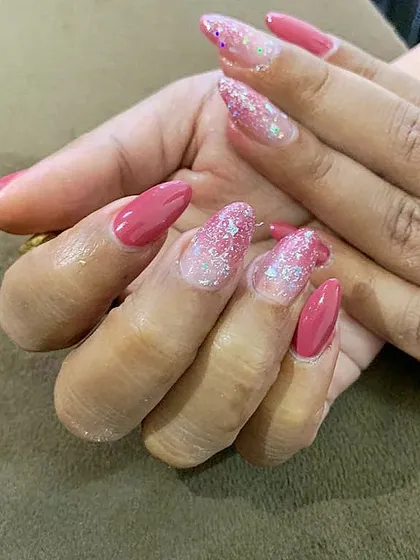 A beautiful combination of solid pink nails and accent nails with a chunky pink and silver glitter gradient.